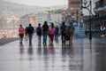 Diverse people strolling along the Paseo de Zarautz, Basque Country.