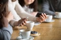 Diverse people using smartphones at cafe table, close up view Royalty Free Stock Photo