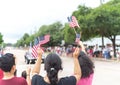 Diverse people waving American flag on Independence Day Street Parade Celebration