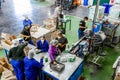 Diverse people working on an assembly line in a glue factory