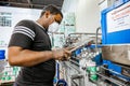 Diverse people working on an assembly line in a glue factory