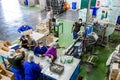 Diverse people working on an assembly line in a glue factory