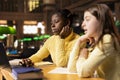 Diverse preteen students in the library engaged in e learning seminar Royalty Free Stock Photo