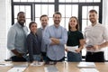 Diverse professional business team standing in office looking at camera Royalty Free Stock Photo