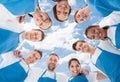 Diverse professional cleaners standing in huddle against sky