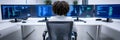 Diverse Programmer Working on Multiple Screens A black individual focused on coding tasks while seated in front of multiple Royalty Free Stock Photo