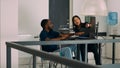 Diverse programmers collaborating on coding project compiling algorithm