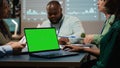 Diverse project staff working at night in office with chroma key on laptop, Royalty Free Stock Photo