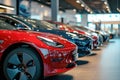 A diverse range of cars neatly arranged in a showroom, available for purchase, A group of modern electric cars of various models