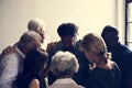 Diverse religious people praying together