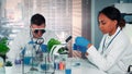 Diverse research specialists working with organic materials in modern bright chemistry lab Royalty Free Stock Photo