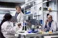 Diverse researchers collaborate in lab with molecular analysis tools Royalty Free Stock Photo