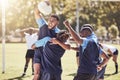 Diverse rugby teammates celebrating scoring a try or winning a match outside on a sports field. Rugby players cheering