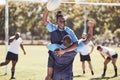 Diverse rugby teammates celebrating scoring a try or winning a match outside on a sports field. Rugby players cheering