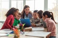 Diverse School Children and Teacher Enjoying a Collaborative Learning Experience in Modern Classroom Royalty Free Stock Photo