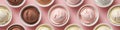 A diverse selection of ice cream flavors presented in charming bowls against a soft pink background Royalty Free Stock Photo