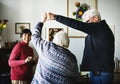 Diverse senior couple dancing at home