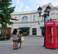 Diverse shoppers are walking on McArthurGlen Designer Outlet Streets. Royalty Free Stock Photo