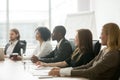 Diverse smiling businesspeople sitting at conference table at gr Royalty Free Stock Photo