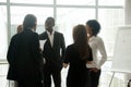 Diverse smiling business people having conversation standing tog Royalty Free Stock Photo