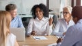 Multiracial employees talk discuss ideas cooperating at briefing