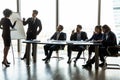 Diverse trainers make whiteboard presentation at team office meeting Royalty Free Stock Photo