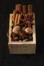 Diverse spices in a wooden box: cinnamon, nutmeg, cardamom, cloves, anise stars
