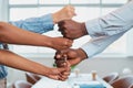 Diverse stacked fists together in teamwork tower, corporate business boardroom