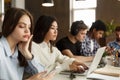 Diverse students sitting at college library, doing homework Royalty Free Stock Photo