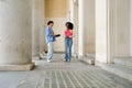 Diverse students talking on university campus hallway Royalty Free Stock Photo