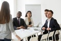 Diverse team being judgmental scolding unpunctual colleague