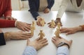 Diverse team of business people join little human figures as symbol of teamwork and collaboration Royalty Free Stock Photo