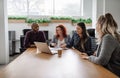 Diverse team of businesspeople meeting together in open bright work space Royalty Free Stock Photo