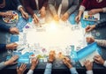 Diverse team collaborates on innovative digital strategy around a glowing table Royalty Free Stock Photo