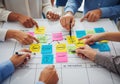 Diverse team collaborating on project strategy with sticky notes Royalty Free Stock Photo