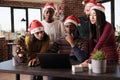 Diverse team of coworkers using laptop in festive office Royalty Free Stock Photo