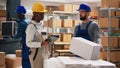 Diverse team of employees scanning boxes barcodes