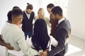 Diverse team of happy young business people standing in office and hugging each other Royalty Free Stock Photo