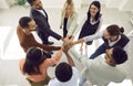 Diverse team of happy young business people standing in circle and stacking hands Royalty Free Stock Photo