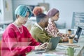 Diverse team of software developers using computers behind glass Royalty Free Stock Photo