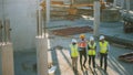 Diverse Team of Specialists Discussing Work on Construction Site. Real Estate Building Project wit Royalty Free Stock Photo