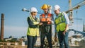 Diverse Team of Specialists Use Tablet Computer on Construction Site. Real Estate Building Project Royalty Free Stock Photo