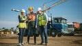 Diverse Team of Specialists Use Tablet Computer on Construction Site. Real Estate Building Project Royalty Free Stock Photo
