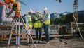 Diverse Team of Specialists Use Tablet Computer on Construction Site. Real Estate Building Project Royalty Free Stock Photo