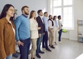 Diverse team of happy young business people standing all together in their office Royalty Free Stock Photo