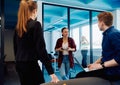 A diverse team of young business people exchanging ideas in a modern startup office Royalty Free Stock Photo