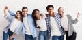 Diverse teenagers embracing and having fun over white wall Royalty Free Stock Photo