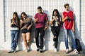 Diverse teenagers with their mobile phones Royalty Free Stock Photo