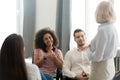 Diverse trainee sitting on office chairs listening mature business coach Royalty Free Stock Photo