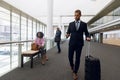 Diverse travelling business people in modern corridor Royalty Free Stock Photo